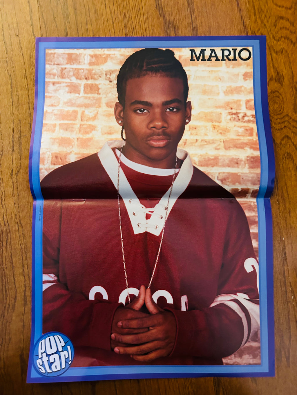 Mario side of Pop Star double-sided poster with blue border and brick background