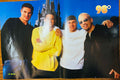 J-14 magazine double-sided poster side A featuring all four members of 98 Degrees posing in front of Cinderella Castle at Disney Magic Kingdom wearing casual outfits, 98 degrees in gold bubble font top right, J-14 logo bottom left, blue sky background