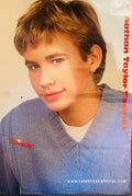 Teen Beat magazine double-sided poster side A featuring Jonathan Taylor Thomas JTT close-up portrait in blue V-neck sweater over white tee with tousled highlighted hair and soft smile, nathan Taylor Thomas in red vertical font right side, Teen Beat logo bottom left, www.celebritysightings.com bottom right