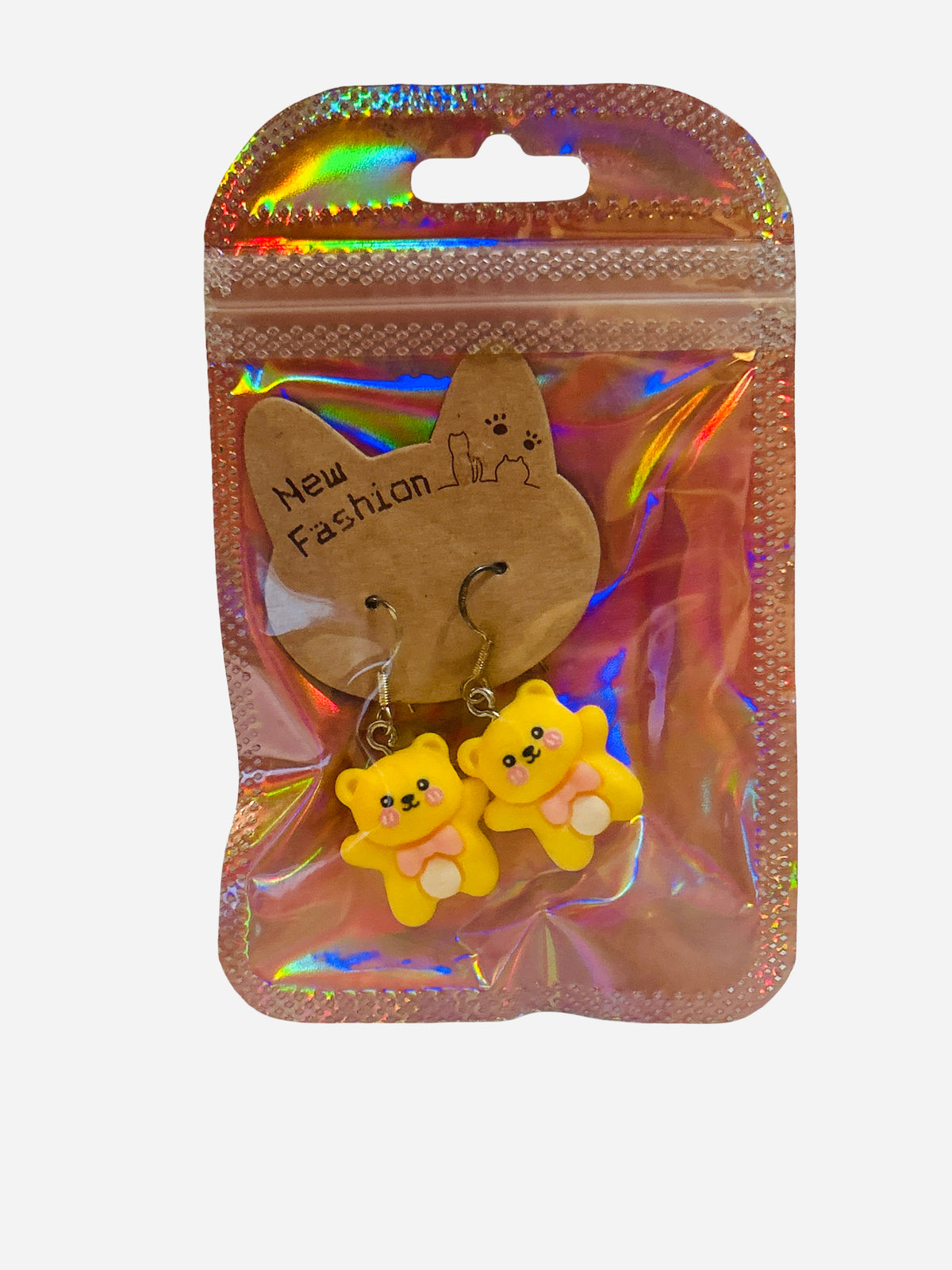 Pair of yellow kawaii teddy bear clay charm drop earrings with pink bow ties on silver fish hook wires, sealed in holographic zip bag with New Fashion cat display card