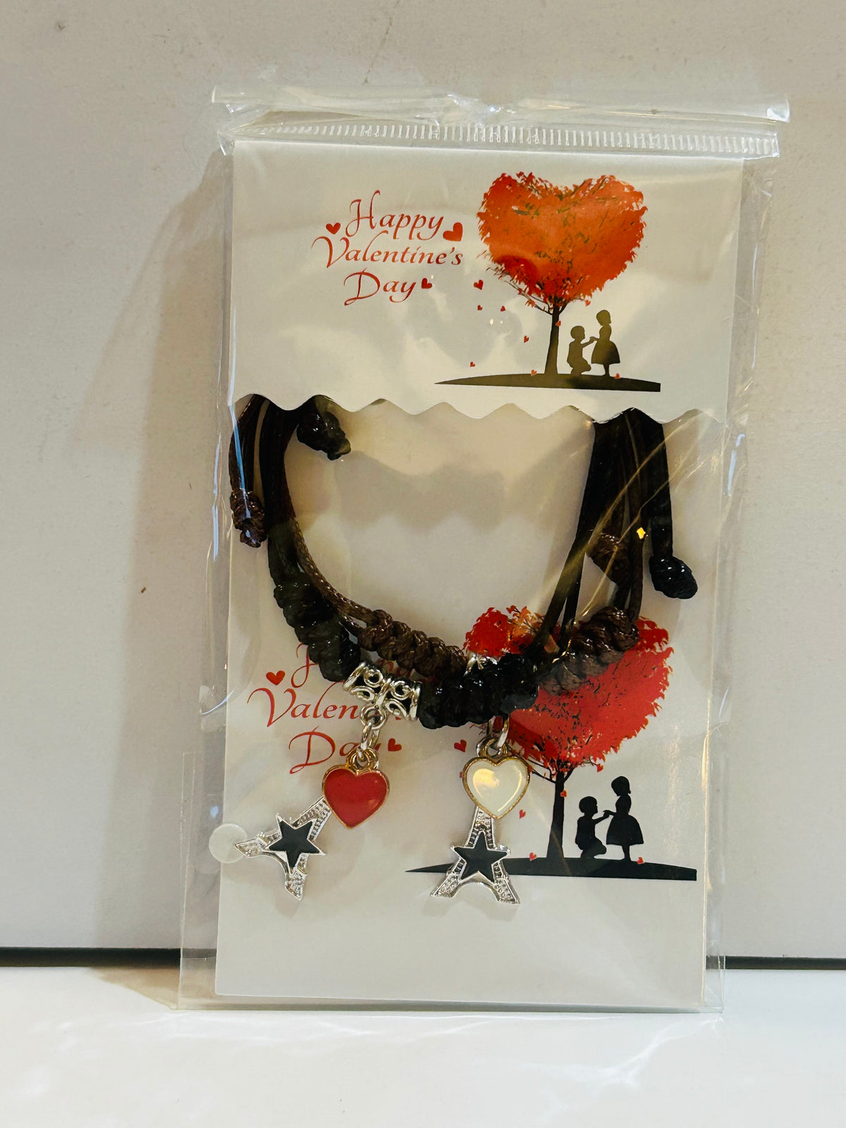 Two Eiffel Tower charm bracelets with heart and star pendants on a Happy Valentine's Day display card, sealed in original packaging