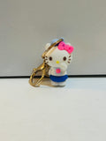 Hello Kitty 3D figure keychain with pink bow, blue skirt, and gold-tone lobster clasp, approximately 2 inches tall
