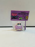 Miniature kawaii angry ghost cake slice resin charm keychain sealed in bag with purple illustrated display card reading That's Because of You and purple ball chain