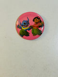 1.5 inch pinback button featuring Stitch and Lilo hula dancing on a pink background from Disney's Lilo & Stitch