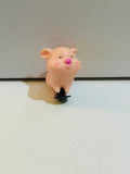 1.5 inch kawaii chubby pink pig figurine with rosy cheeks, pink snout, happy expression, and small black suction cup base