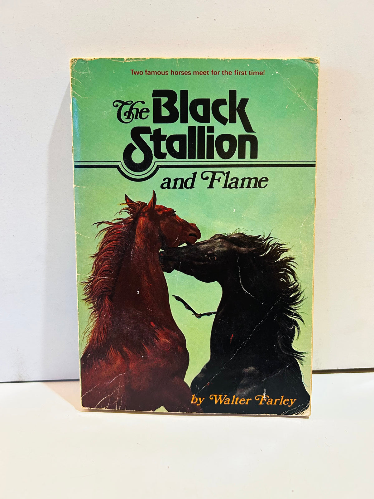 Green cover of The Black Stallion and Flame by Walter Farley featuring two rearing horses