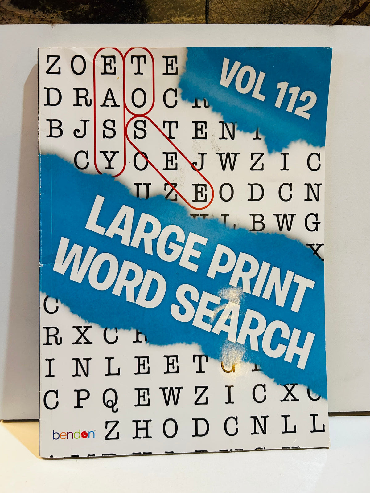 Bendon Large Print Word Search Volume 112 paperback cover with bold letter grid background and blue cloud design with Vol 112 and Large Print Word Search text