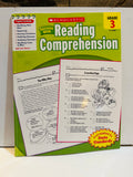 Scholastic Success With Reading Comprehension Grade 3 spiral-bound workbook cover, green and yellow design, correlated to State Standards, with sample worksheet pages fanned out in front