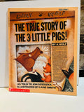 The True Story of the 3 Little Pigs paperback cover designed as Daily Wolf newspaper front page, written by A. Wolf as told to Jon Scieszka, illustrated by Lane Smith, Scholastic 1991, previous owner name written on top corner