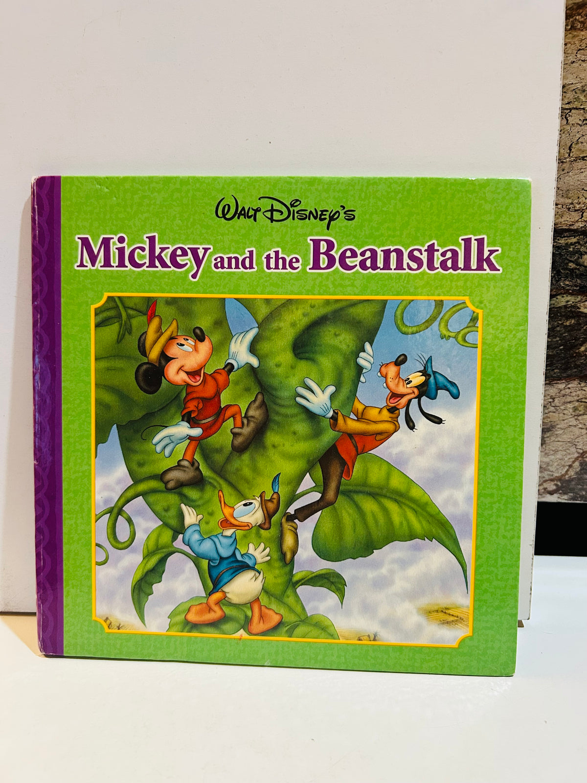 Walt Disney's Mickey and the Beanstalk 8x8 hardcover book cover featuring Mickey Mouse, Donald Duck, and Goofy climbing a giant green beanstalk, 2007 edition