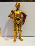 Star Wars C-3PO 10 inch action figure with signature red left arm from The Force Awakens Episode VII standing upright showing full gold metallic finish with detailed articulated joints and exposed wiring at midsection