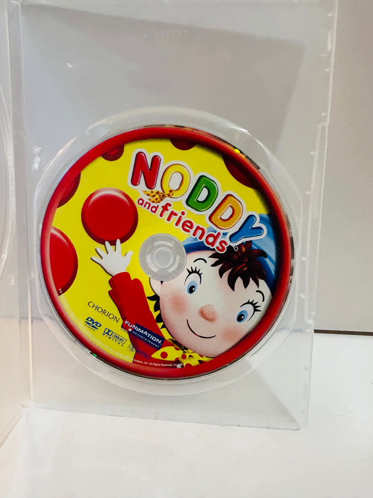 Noddy and Friends DVD disc in clear plastic sleeve showing colorful disc label with Noddy smiling and waving with red balloons yellow background Chorion and Funimation Entertainment logos