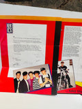 New Kids on the Block Official Fan Club 1990 brochure spread showing welcome letter signed by all 5 members with NKOTB logo, classic group photo of Donnie Joey Danny Jordan and Jonathan, and solo photo of Jordan Knight on motorcycle wearing Syndicate shirt, red and orange mailer background