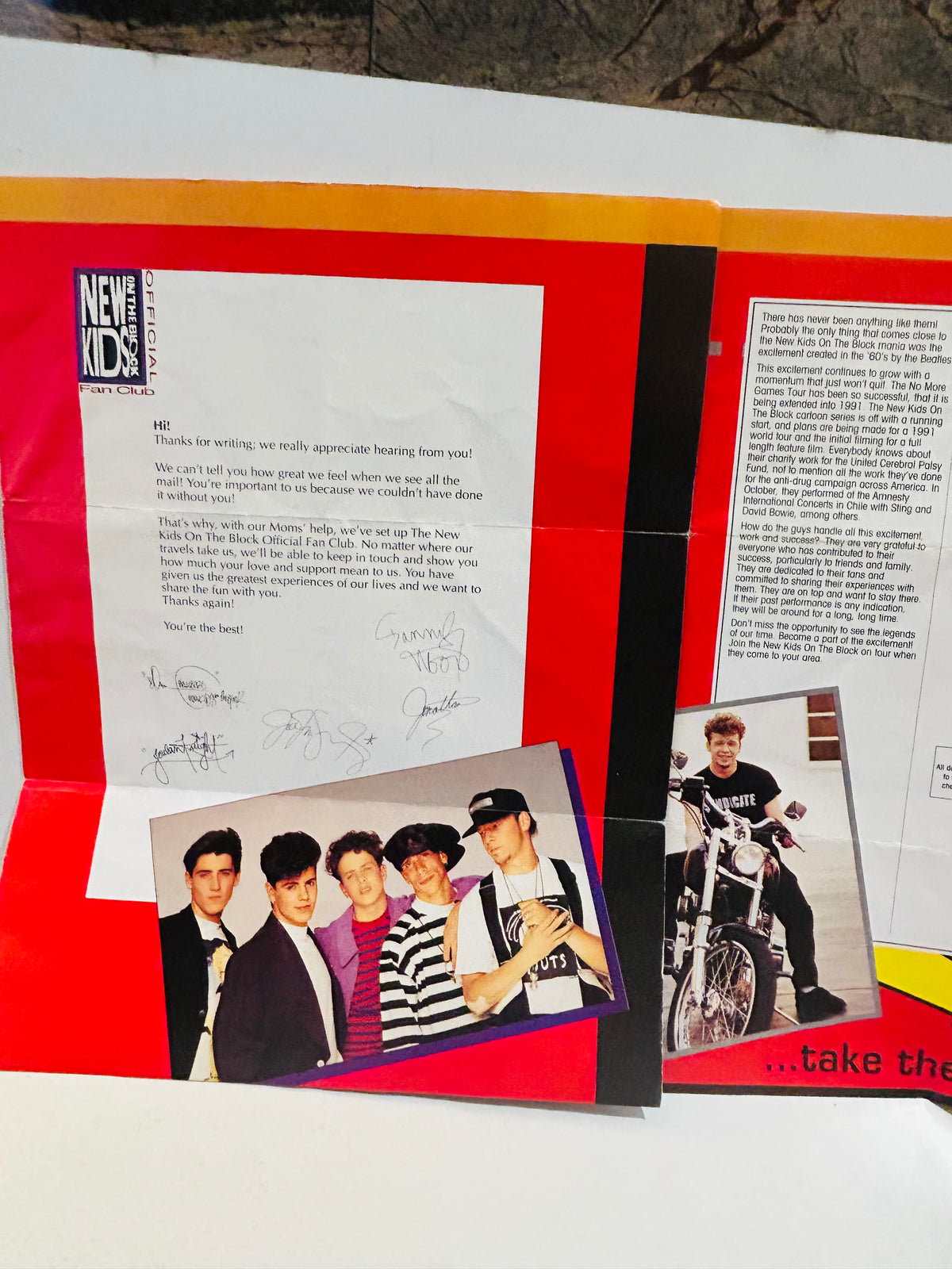 New Kids on the Block Official Fan Club 1990 brochure spread showing welcome letter signed by all 5 members with NKOTB logo, classic group photo of Donnie Joey Danny Jordan and Jonathan, and solo photo of Jordan Knight on motorcycle wearing Syndicate shirt, red and orange mailer background
