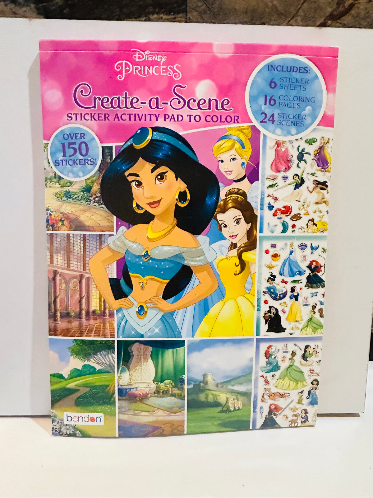 Disney Princess Create-a-Scene Sticker Activity Pad to Color 2018 Bendon cover featuring Jasmine Cinderella and Belle with over 150 stickers 6 sticker sheets 16 coloring pages 24 sticker scenes callouts on pink background