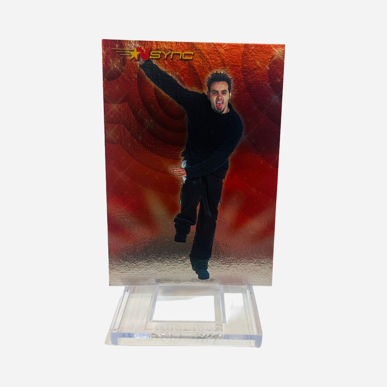 NSYNC Trading Card #12 Front – Chris Kirkpatrick All-Black Outfit Arm Raised Tongue Out Mid-Jump Fiery Red Swirl Background 2000 Topps Winterland