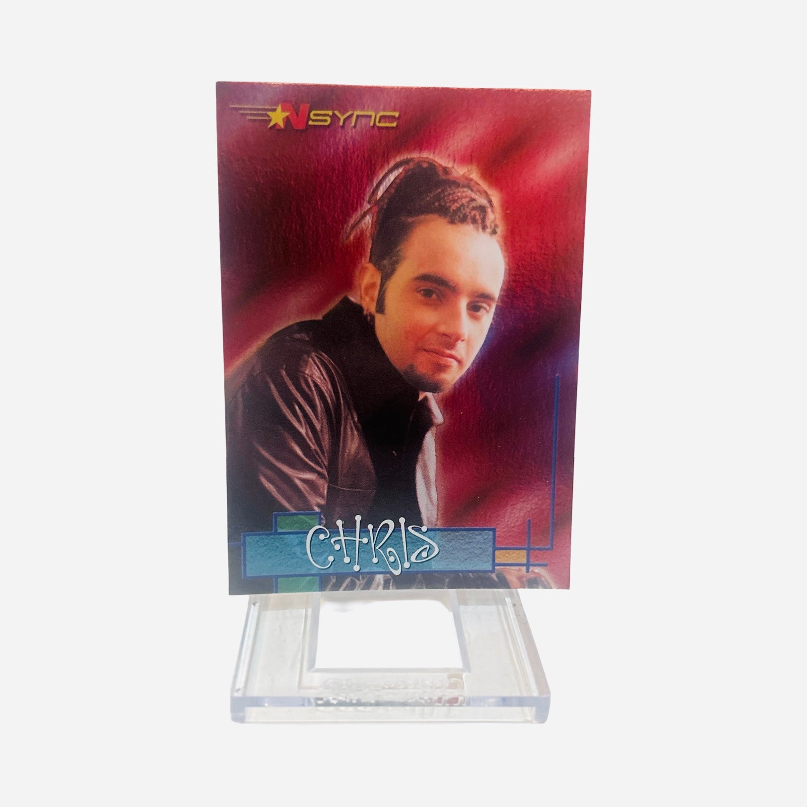 NSYNC Trading Card #24 Front – Chris Kirkpatrick Braided Highlighted Hair Dark Leather Jacket Soft Smile Red Purple Atmospheric Background 2000 Topps Winterland