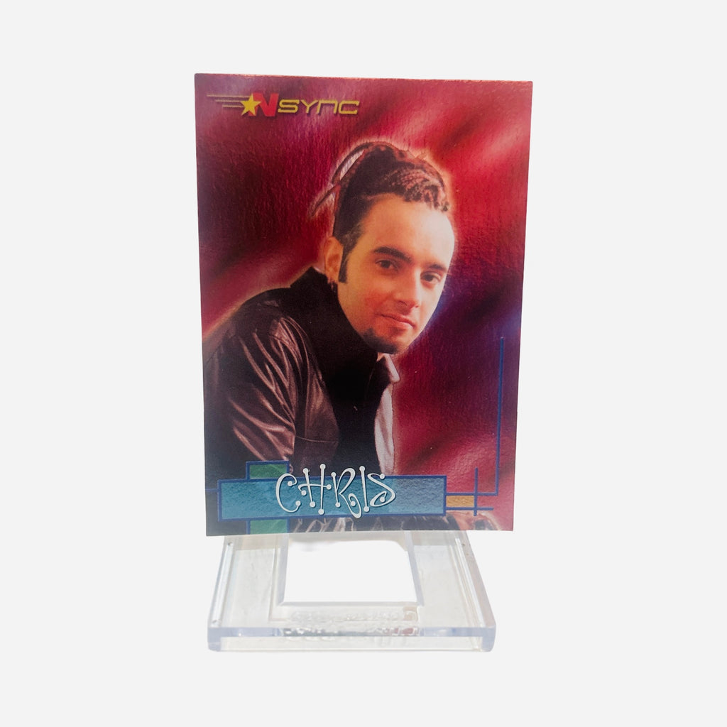 NSYNC Trading Card #24 Front – Chris Kirkpatrick Braided Highlighted Hair Goatee Dark Leather Jacket Soft Smile Rich Red Purple Atmospheric Background 2000 Topps Winterland
