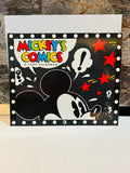 Mickey's Comics A 1993 Calendar front cover – black polka dot background with Mickey Mouse silhouette, colorful comic-style title