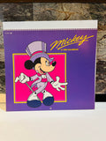 Mickey A 1990 Calendar front cover – purple background with Mickey Mouse in top hat and tuxedo, published by CLEO