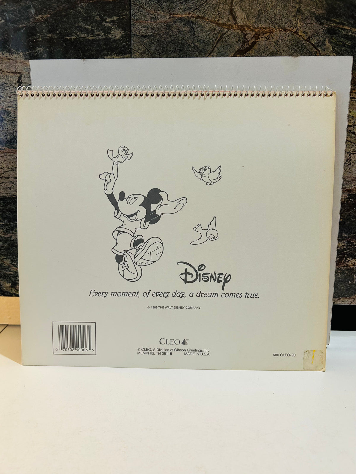 Mickey A 1990 Calendar back cover – black and white Mickey with birds, Disney quote 'Every moment, of every day, a dream comes true', CLEO/Gibson Greetings