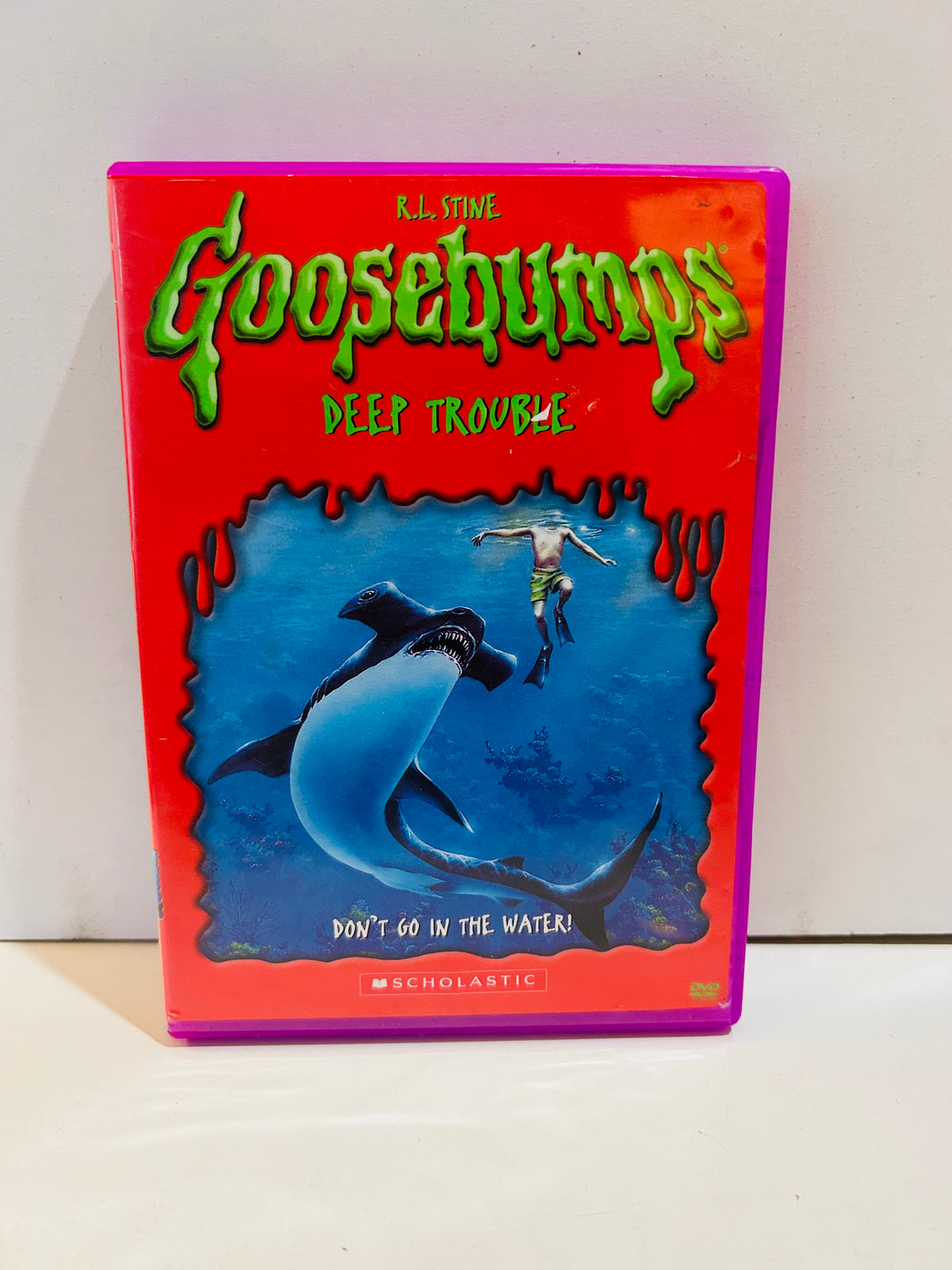 R.L. Stine Goosebumps Deep Trouble DVD in a purple case with underwater shark cover artwork