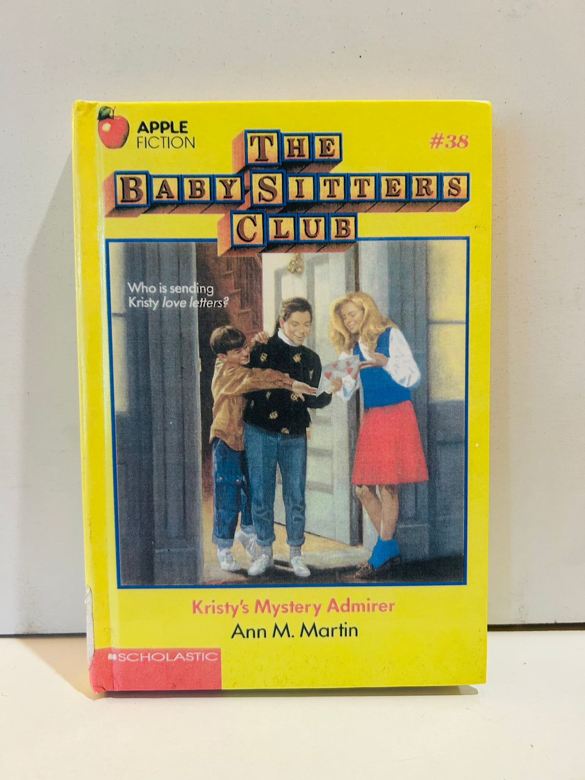 First-edition ex-library hardcover of Kristy's Mystery Admirer, showing red #38 marking and Apple Fiction logo on the cover