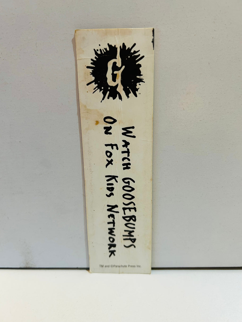 Back of preowned Goosebumps bookmark showing wear and discoloration