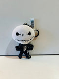 Jack Skellington plush keychain with attached tags and black pinstriped outfit
