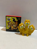 Gold-colored Keroppi King Ghidorah three-headed figure beside its illustrated box