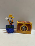Smitty Werbenjagermanjensen x Brook skeleton figure with yellow crown hat on a blue base beside its illustrated box