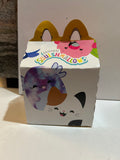 Preowned McDonald's Original Squishmallows Happy Meal box with colorful character artwork and yellow arch handles