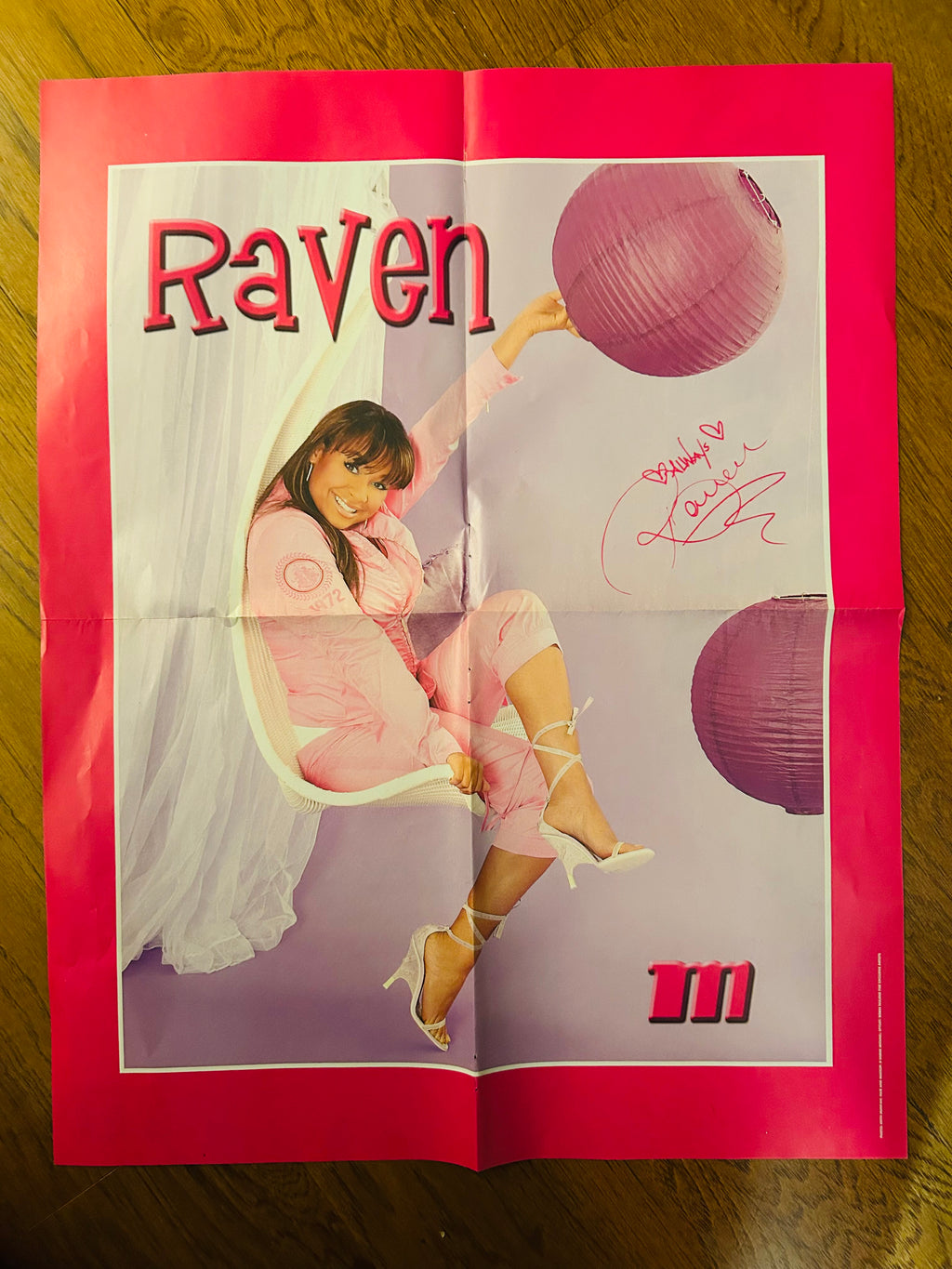 Raven poster side with pink outfit and red border, showing fold creases