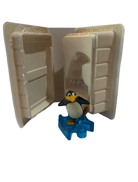 Penguin figure on blue ice base in original clamshell packaging from The Little Mermaid II