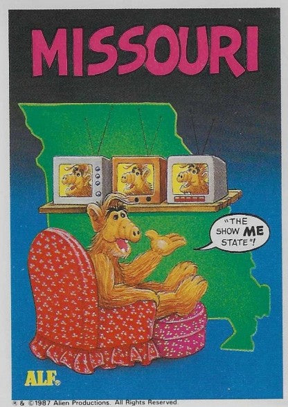U.S. of ALF Missouri sticker featuring ALF in red armchair watching himself on three stacked CRT televisions saying The Show ME State