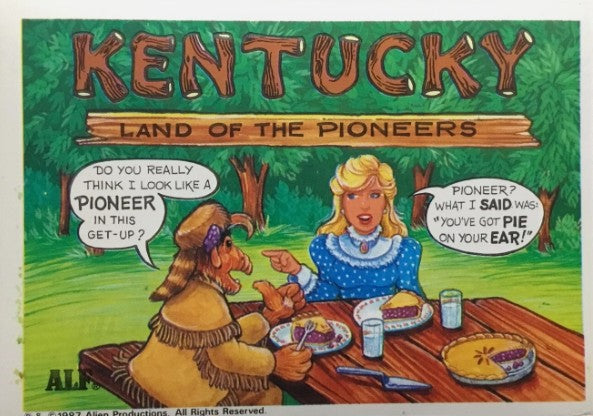 U.S. of ALF Kentucky sticker featuring ALF in pioneer coonskin cap at picnic table with woman in blue dress and two pies