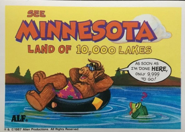 U.S. of ALF Minnesota sticker featuring ALF in sunglasses and floral trunks floating in inner tube on lake with frog saying only 9999 lakes to go