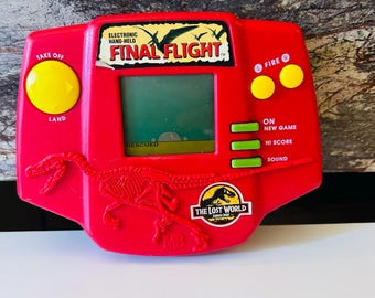 Jurassic Park 1996 Handheld Video Game (BATTERIES NOT INCLUDED) Lost World Final Flight Game